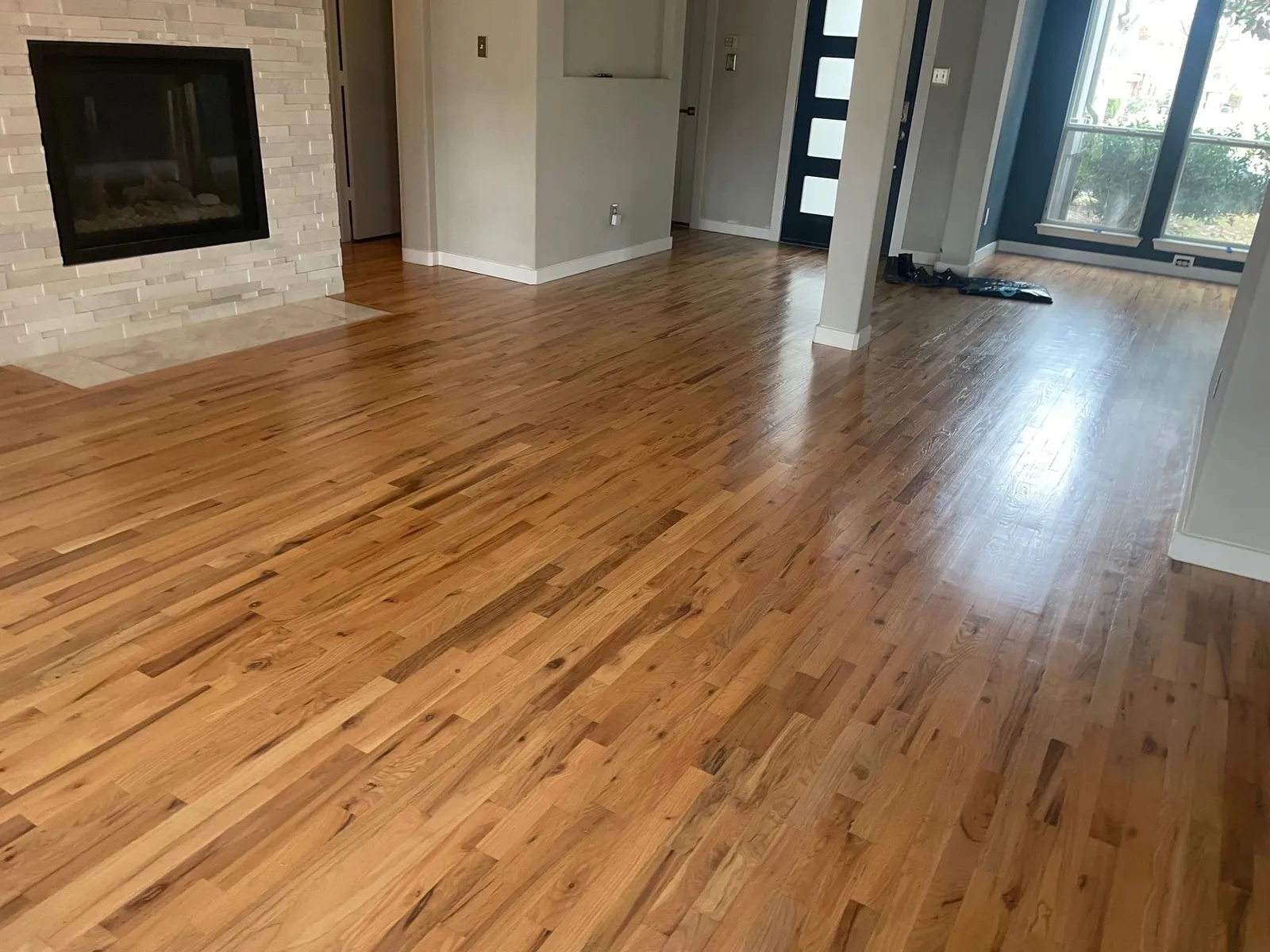 Refinished red oak hardwood flooring flowing through a great room in a McKinney TX home